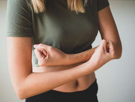 Slim Womans shows her muscled arm. People, sport, fitness and health concept. Selective focusの写真素材