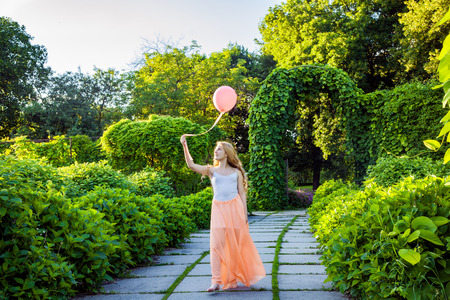 Beautiful girl with balloon have a fun in the park.の写真素材