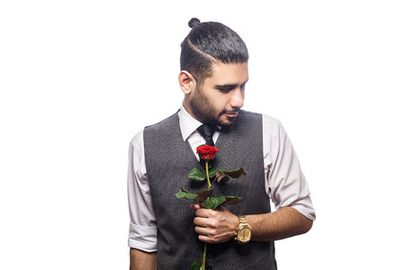 Handsome romantic happy man with rose flower. studio shot. isolated on white background. holding rose with full of emotion.の写真素材