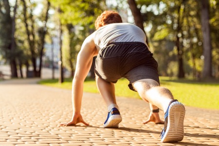 Jogging in park. Treeadwill. Fitness model in crossfit exercise outdoors. Healthy lifestyle concept.