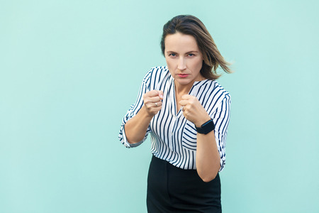Boxing. business woman, ready for fight on light blue background. Studio shotの写真素材