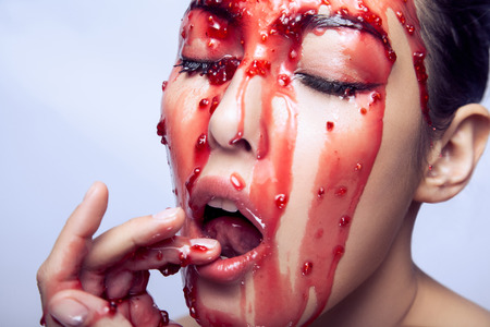 Passion model open mouth touching fingers her lips and tries to catch jam on her face. Indoor shot