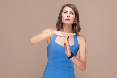 Woman need time out. Studio shot on light brown backgroundの写真素材