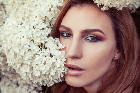 Perfect makeup, eye, lipsick and lips. Model looking at camera. Outdoor spring or summer photoの写真素材