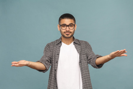 Portrait of bearded handsome man with black glasses in casual style looking at camera smiling....