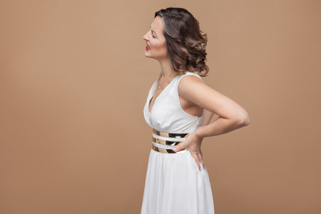 Woman unwell. Have pain in back spine. Emotion and feeling concept. Studio shot, indoor, isolated on...