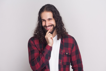 Portrait Of Playful Handsome Man With Beard And Black Long