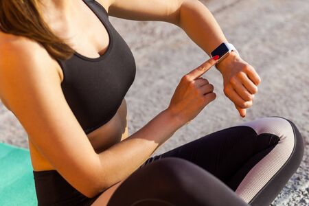 Closeup portrait of young girl wearing black sporwear practicing sport exercises in morning on...