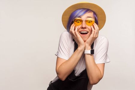 Wow i can't believe! Portrait of amazed fashionable hipster girl with violet short hair in...