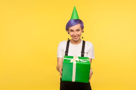 Take birthday present! Portrait of generous cute hipster girl with violet short hair wearing funny...