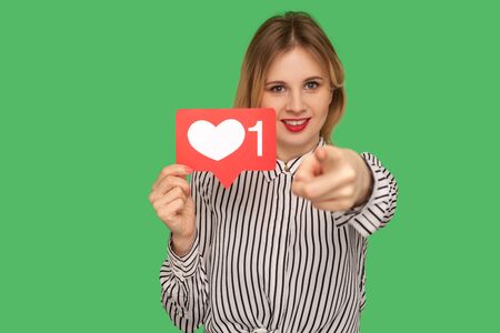 Hey you, put like to content! Pretty girl with red lips in glamour blouse holding social media heart...