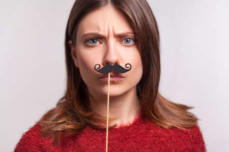 Happy lovely girl in VR glasses headset holding flowers bouquet and smiling flirtatious, playing virtual date in cyberspace augmented reality, dreaming of romantic relations. neon light studio shotの写真素材