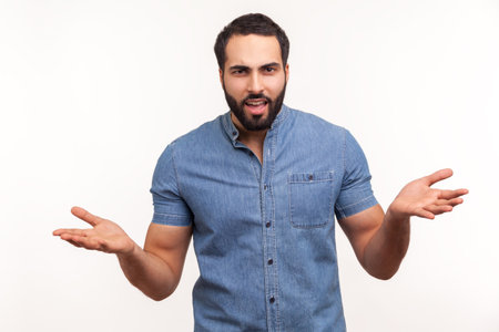 How could you? Irritated annoyed man with beard has problems, gesticulating with hands, crisis and negativity, misunderstanding. Indoor studio shot isolated on white backgroundの写真素材