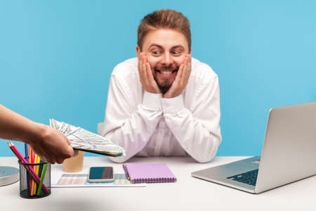 Extremely happy excited bearded man office worker looking at big sum of money in unknown person...