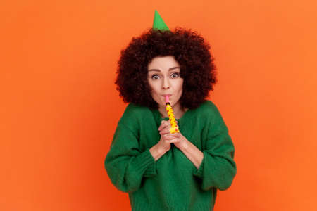 Happy birthday! Portrait of festive woman with curly hair wearing green casual style sweater and...