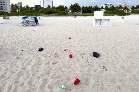 Miami, Florida - August 25th, 2023: Plastic garbage on a beach with city on background in Miami, Florida.のeditorial素材