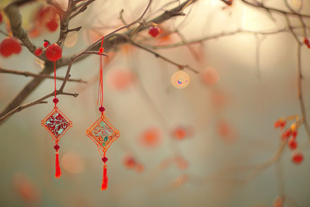 Red earrings on the branches of a tree in the forest.の素材