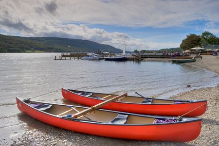 Canoes on the shore of Coniston Water in the English lake Districtの写真素材