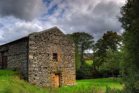 A stone built barn in summer evening lightの写真素材