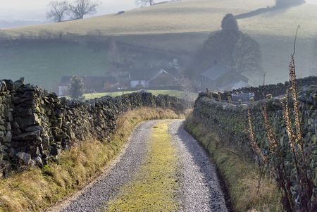 A track leading to a farm on a hazy day in the English Lake Districtの写真素材