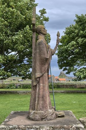 The Statue of St Aidan in the grounds of Lindisfarne Castle, Holy Island, North East Englandの写真素材