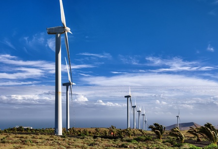 Scenic view of wind farm in countryside with blue sky and cloudscape background, Lanzarote, Canary...