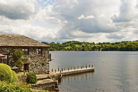 A stone built house on the edge of a lakeの写真素材