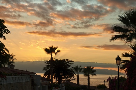 Sunset at Los Gigantes in the Spanish Canary islands with the island of La Gomera on the horizonの写真素材