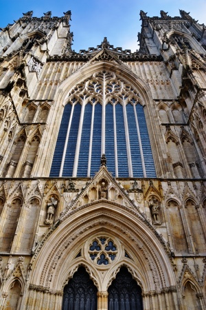 The oak entrance doors and west stained glass window at York MinsterCathedral, York, England...