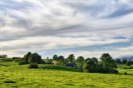 A secluded farmhouse in rolling English Lake District countryside