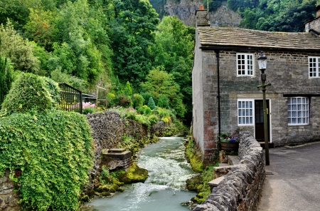 View of a stone built cottage by a river in the village of Castleton,Edale, in