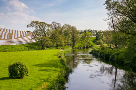 River Bela flowing through farmland in Cumbria, Englandの写真素材