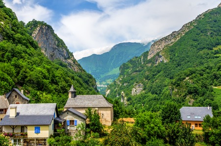 The village of Borce in the Fench Pyrenees, with a mountain and valley backdropの写真素材