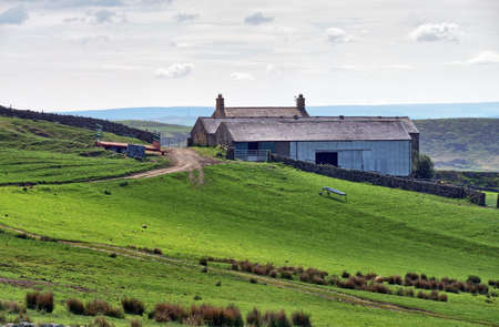 A rural farmhouse on a slope in Northumberlandの写真素材
