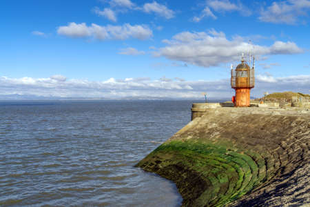 The red lighthouse at the entrance to Heysham harbourの写真素材