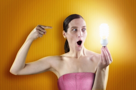 nice young girl holding a lighting bulbの写真素材