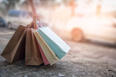 Women carry shopping bags of many colors in hand, discount shopping concept.の写真素材