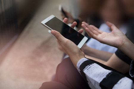 Mockup image of white mobile phone with blank black screen.の写真素材