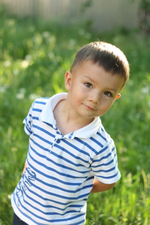 Portrait of a boy on a green gladeの写真素材