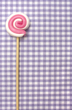 Spiral lolly pop candy  on background in purple celluleの写真素材