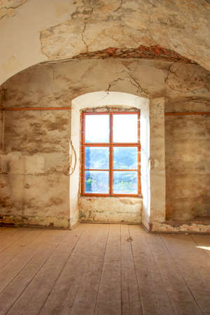 Window in an old house with grunge wall and wooden floor