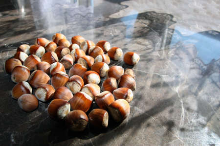Shelled hazelnut on wooden table background.の写真素材