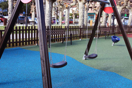 Empty playground with swing and merry-go-round