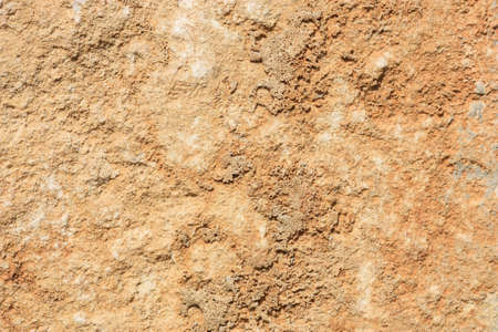 Yellow stone wall background. Yellow gray building blocks texture. Stone wall with stains.