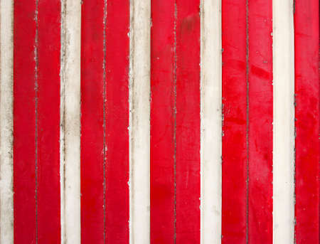 Red and white metal fence background. Rustic metal construction in red and white metallic shapes. Industry concept.の写真素材