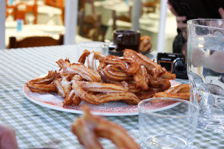 Churos spanish dessert on a table in a cafe.の写真素材