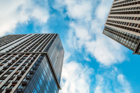 Bottom view of modern skyscraper against blue sky.の写真素材