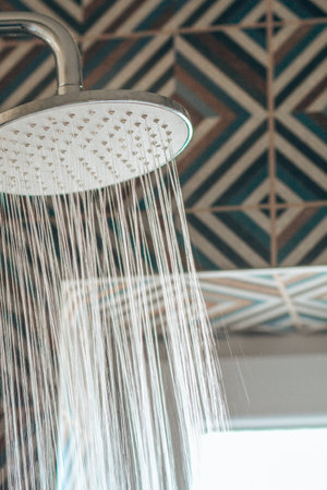 Bathroom shower head spraying waterの写真素材