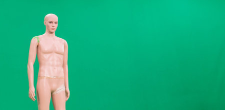 Dummy men's shirts standing naked in the green screen of virtual studio broacasting and used as a model for lighting setup.の写真素材