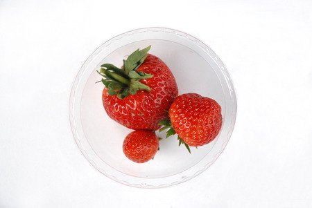 Strawberry red berries in glass with white backgroundの写真素材